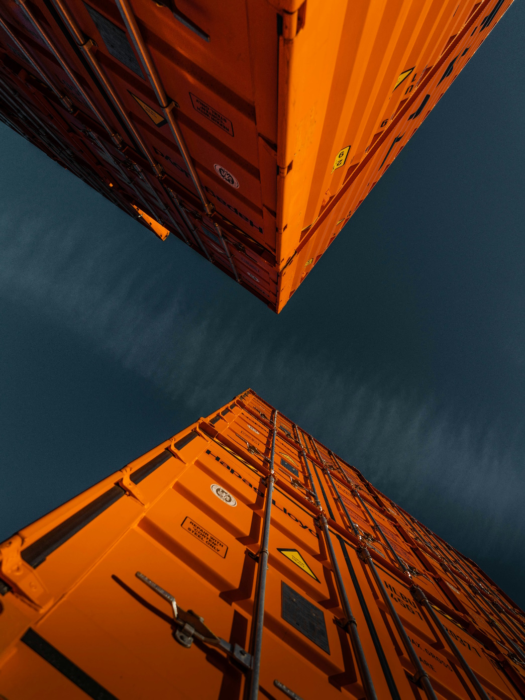 Shipping continers stacked looking up against sky