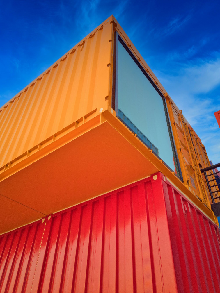 Container with window stacked looking up from ground at clear blue sky