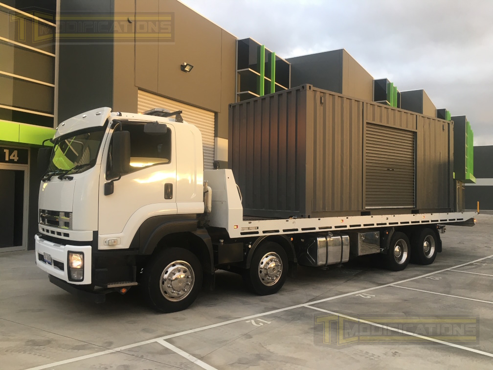 Shipping container on delivery truck on road